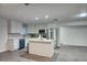 Modern kitchen with stainless steel appliances, island, white cabinets, and tile backsplash at 4202 W Purdue Ave, Phoenix, AZ 85051