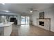 Living room features fireplace, ceiling fan, and sliding door access to the outdoor pool at 4202 W Purdue Ave, Phoenix, AZ 85051
