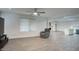 Open concept living area with modern ceiling fan, updated flooring, and brick fireplace at 4202 W Purdue Ave, Phoenix, AZ 85051