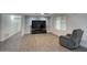 Spacious living room featuring contemporary flooring, a brick accent wall, and a comfortable recliner at 4202 W Purdue Ave, Phoenix, AZ 85051