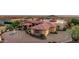 Custom home featuring a circular driveway, a grand entrance, mature landscaping, and a beautiful red tile roof at 4328 N Pinnacle Ridge Cir, Mesa, AZ 85207