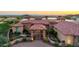 Luxury home featuring a grand entrance, tile roof, circular driveway, mature landscaping and panoramic desert views at 4328 N Pinnacle Ridge Cir, Mesa, AZ 85207