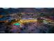 An aerial twilight view of a luxurious home with a curved pool surrounded by desert landscaping, offering serene desert living at 4328 N Pinnacle Ridge Cir, Mesa, AZ 85207