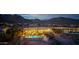Twilight aerial view showcases a home with a pool, mountain views, and an inviting outdoor living space at 4328 N Pinnacle Ridge Cir, Mesa, AZ 85207