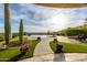 A well-manicured backyard featuring vibrant flowers, a paved pathway, and desert landscaping at 4328 N Pinnacle Ridge Cir, Mesa, AZ 85207