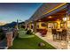 Luxurious outdoor space with putting green, patio, seating area, and covered area at 4328 N Pinnacle Ridge Cir, Mesa, AZ 85207
