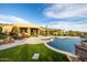 A luxurious backyard pool with a built-in spa and desert landscaping, creating an ideal outdoor oasis at 4328 N Pinnacle Ridge Cir, Mesa, AZ 85207