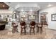 Custom home bar with stone accents, decorative lighting, and seating for four at 4328 N Pinnacle Ridge Cir, Mesa, AZ 85207