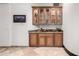 A beautiful bar area featuring granite countertops and custom cabinetry with glass door display cases at 4328 N Pinnacle Ridge Cir, Mesa, AZ 85207