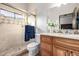 Bright bathroom featuring tile shower, vanity, sink, and fixtures at 4328 N Pinnacle Ridge Cir, Mesa, AZ 85207