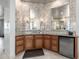 Bathroom vanity with stone countertops, wood cabinets, two mirrors, sconces, and a stainless steel beverage cooler at 4328 N Pinnacle Ridge Cir, Mesa, AZ 85207