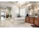 Luxurious bathroom with a jetted tub, chandelier, and marble accents offers a spa-like experience at 4328 N Pinnacle Ridge Cir, Mesa, AZ 85207