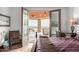 Bedroom with a luxurious king-size bed and access to a covered patio overlooking a beautiful desert landscape at 4328 N Pinnacle Ridge Cir, Mesa, AZ 85207