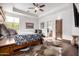 A primary bedroom featuring hardwood floors, ceiling fan, and ensuite bathroom at 4328 N Pinnacle Ridge Cir, Mesa, AZ 85207