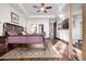Spacious primary bedroom featuring hardwood floors, ceiling fan, and walk-in closet at 4328 N Pinnacle Ridge Cir, Mesa, AZ 85207