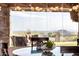 The breakfast nook features lovely greenery as a centerpiece and a large window with seating outside at 4328 N Pinnacle Ridge Cir, Mesa, AZ 85207