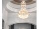 A stunning crystal chandelier adds elegance to the entryway, enhancing the home's luxurious ambiance at 4328 N Pinnacle Ridge Cir, Mesa, AZ 85207