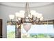 Close up on chandelier in the breakfast nook area with the backdrop of the desert mountain scene at 4328 N Pinnacle Ridge Cir, Mesa, AZ 85207
