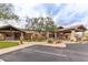 Community clubhouse entrance with covered drop-off, desert landscaping and parking area at 4328 N Pinnacle Ridge Cir, Mesa, AZ 85207