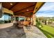 Outdoor patio with comfortable seating, a wooden ceiling, and view of the manicured backyard at 4328 N Pinnacle Ridge Cir, Mesa, AZ 85207