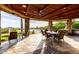 An outdoor dining area with a stone-covered patio, elegant dining set, and beautiful desert views at 4328 N Pinnacle Ridge Cir, Mesa, AZ 85207
