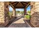 Grand stone entrance with a fountain and desert landscaping that leads to the home at 4328 N Pinnacle Ridge Cir, Mesa, AZ 85207
