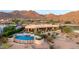 Estate exterior view with private pool, spa, desert landscaping and views of surrounding mountains at 4328 N Pinnacle Ridge Cir, Mesa, AZ 85207