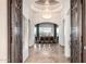 Open foyer with ornate mosaic tile, an elegant chandelier, and dining room with scenic outdoor views at 4328 N Pinnacle Ridge Cir, Mesa, AZ 85207