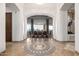 Elegant foyer features mosaic tile inlay, arched doorways, and a dining area with scenic backyard views at 4328 N Pinnacle Ridge Cir, Mesa, AZ 85207