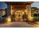 Grand entrance featuring custom iron gate, stone accents and professional landscape lighting at 4328 N Pinnacle Ridge Cir, Mesa, AZ 85207