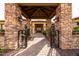 A luxurious home featuring an arched stone entrance with iron gates and beautiful desert landscaping at 4328 N Pinnacle Ridge Cir, Mesa, AZ 85207
