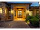 Inviting front entrance with custom iron double doors, beautiful stone accents, and professional landscaping at 4328 N Pinnacle Ridge Cir, Mesa, AZ 85207
