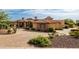 Lovely home exterior featuring professional landscaping, stone accents, fountain and paver driveway at 4328 N Pinnacle Ridge Cir, Mesa, AZ 85207