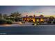 Beautiful home featuring professional landscaping, stone accents, and a paver driveway at twilight at 4328 N Pinnacle Ridge Cir, Mesa, AZ 85207