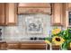 Elegant kitchen backsplash featuring decorative tile and a pot filler faucet at 4328 N Pinnacle Ridge Cir, Mesa, AZ 85207
