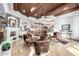 Open concept living room with stone fireplace, wood ceiling, kitchen in background, and lots of seating at 4328 N Pinnacle Ridge Cir, Mesa, AZ 85207
