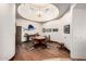 Game room with custom wood cabinets, round table, and hardwood floors under a tray ceiling at 4328 N Pinnacle Ridge Cir, Mesa, AZ 85207