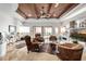 Bright and airy living room with wood ceiling, stone accents, and leather seating area with outdoor view at 4328 N Pinnacle Ridge Cir, Mesa, AZ 85207