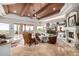 Living room with wood ceiling, stone fireplace, flatscreen TV, and covered outdoor patio in background at 4328 N Pinnacle Ridge Cir, Mesa, AZ 85207