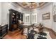 Office featuring wood floors, decorative ceiling, built-in bookcase, and large desk at 4328 N Pinnacle Ridge Cir, Mesa, AZ 85207