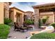 Outdoor seating area with plush chairs and ottomans, complemented by mature landscaping and stunning architecture at 4328 N Pinnacle Ridge Cir, Mesa, AZ 85207