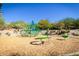 Community playground with various play structures and a wood chip ground cover on a sunny day at 4328 N Pinnacle Ridge Cir, Mesa, AZ 85207