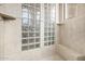 Detail of walk-in shower featuring tile, glass block windows, a tile bench, and chrome fixtures at 4328 N Pinnacle Ridge Cir, Mesa, AZ 85207