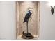 Unique statue of a heron and turtle displayed in a niche with custom lighting and tile background at 4328 N Pinnacle Ridge Cir, Mesa, AZ 85207
