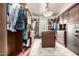 Large walk-in closet with custom wood shelving and drawers, a center island, and carpet at 4328 N Pinnacle Ridge Cir, Mesa, AZ 85207