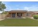 Private backyard with artificial turf and covered patio perfect for relaxation and entertainment at 4404 W Ellis St, Laveen, AZ 85339