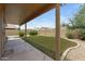 This peaceful backyard offers an artificial lawn, trimmed bushes, and a shaded patio space at 4404 W Ellis St, Laveen, AZ 85339