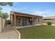 Charming backyard with artificial turf, covered patio, offering great outdoor living at 4404 W Ellis St, Laveen, AZ 85339