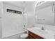 Traditional bathroom featuring a tub with white tiled walls and a vanity with mirror at 4404 W Ellis St, Laveen, AZ 85339