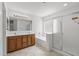 Well-lit bathroom with double vanity, separate shower, and soaking tub at 4404 W Ellis St, Laveen, AZ 85339
